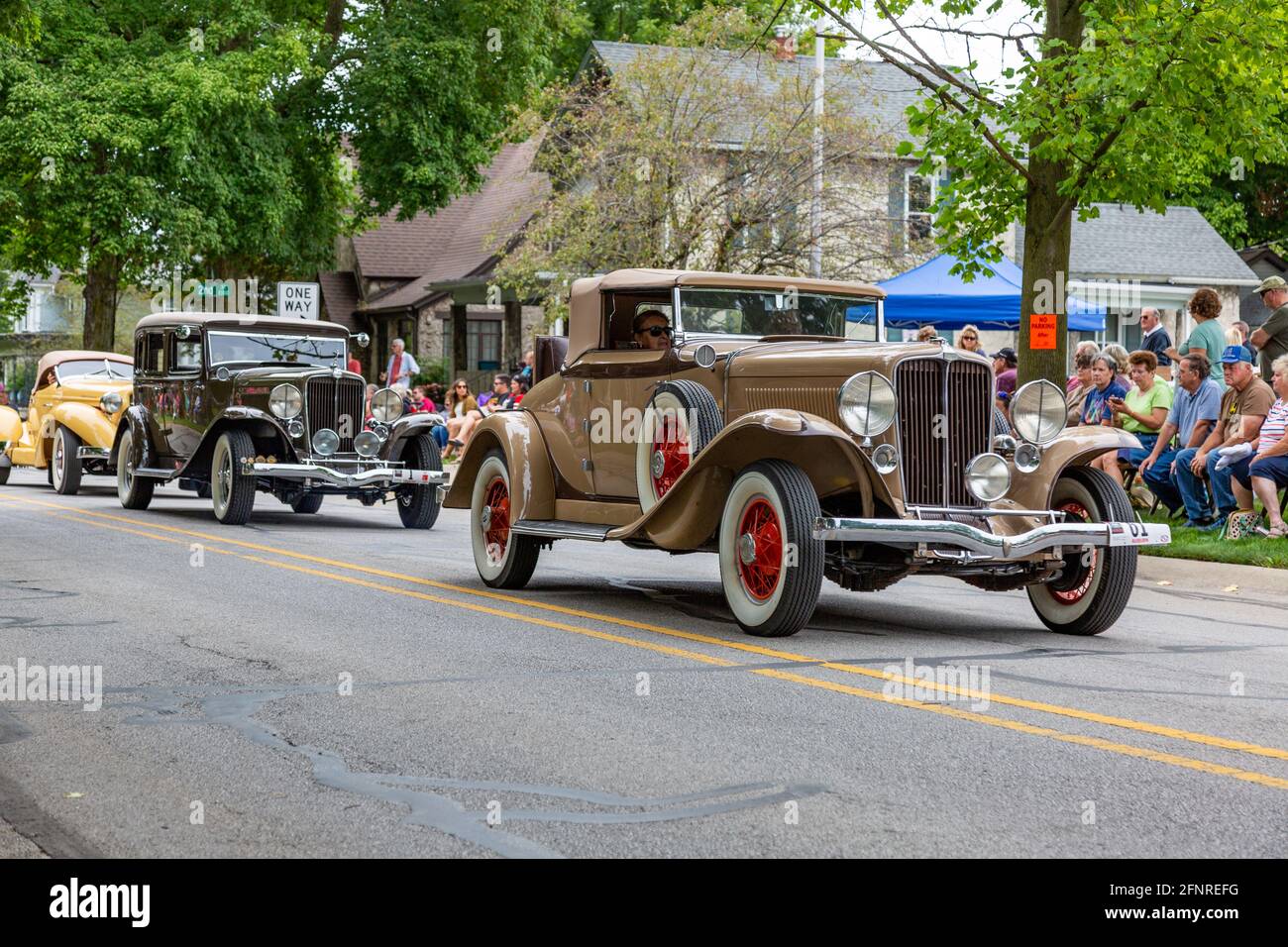 Three antique Auburns pass through Auburn, Indiana during the 2019 Auburn Cord Duesenberg Festival Parade. Stock Photo