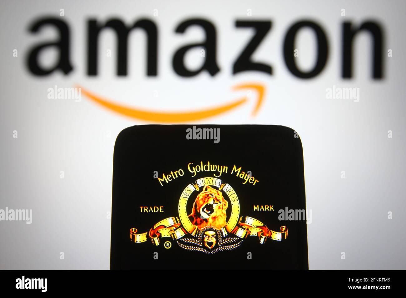 Ukraine. 18th May, 2021. In this photo illustration the Metro-Goldwyn-Mayer (MGM) logo of US media company is seen on a smartphone screen with an Amazon logo in the background. (Photo by Pavlo Gonchar/SOPA Images/Sipa USA) Credit: Sipa USA/Alamy Live News Stock Photo