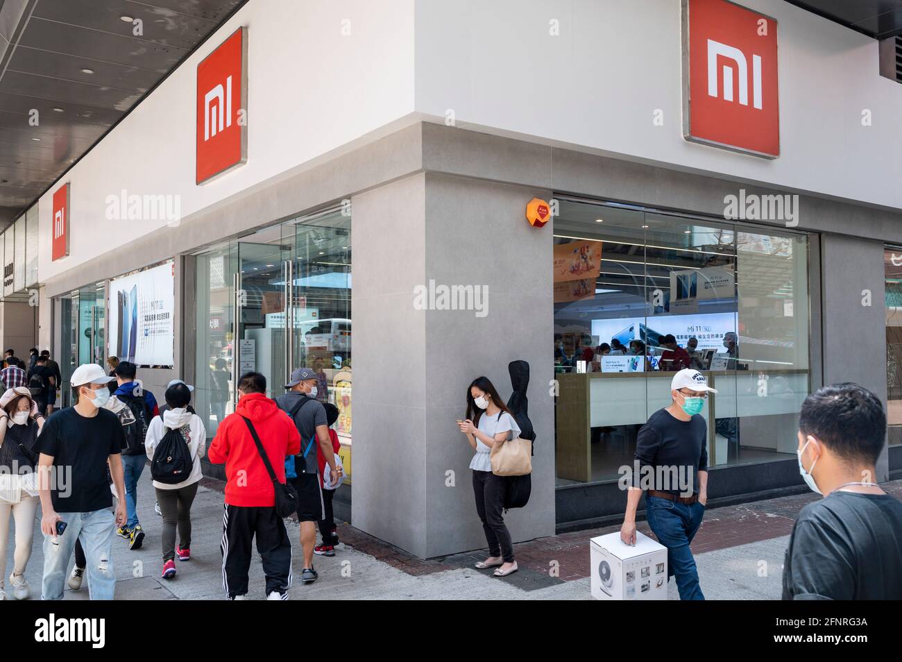 Hong Kong, China. 18th May, 2021. Pedestrians walk past the Chinese  multinational technology and electronics brand Xiaomi flagship store seen  in Hong Kong. (Photo by Budrul Chukrut/SOPA Images/Sipa USA) Credit: Sipa  USA/Alamy