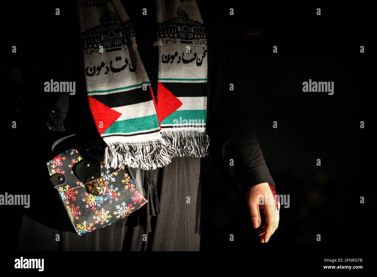 Ankara, Turkey. 18th May, 2021. A protester seen in a scarf with a Palestinian flag pattern during the demonstration.Protesters under the leadership of the Anatolian Youth Association (AGD) formed a vehicle convoy to K?z?lay square to protest Israel's policies towards Palestine. (Photo by Tunahan Turhan/SOPA Images/Sipa USA) Credit: Sipa USA/Alamy Live News Stock Photo