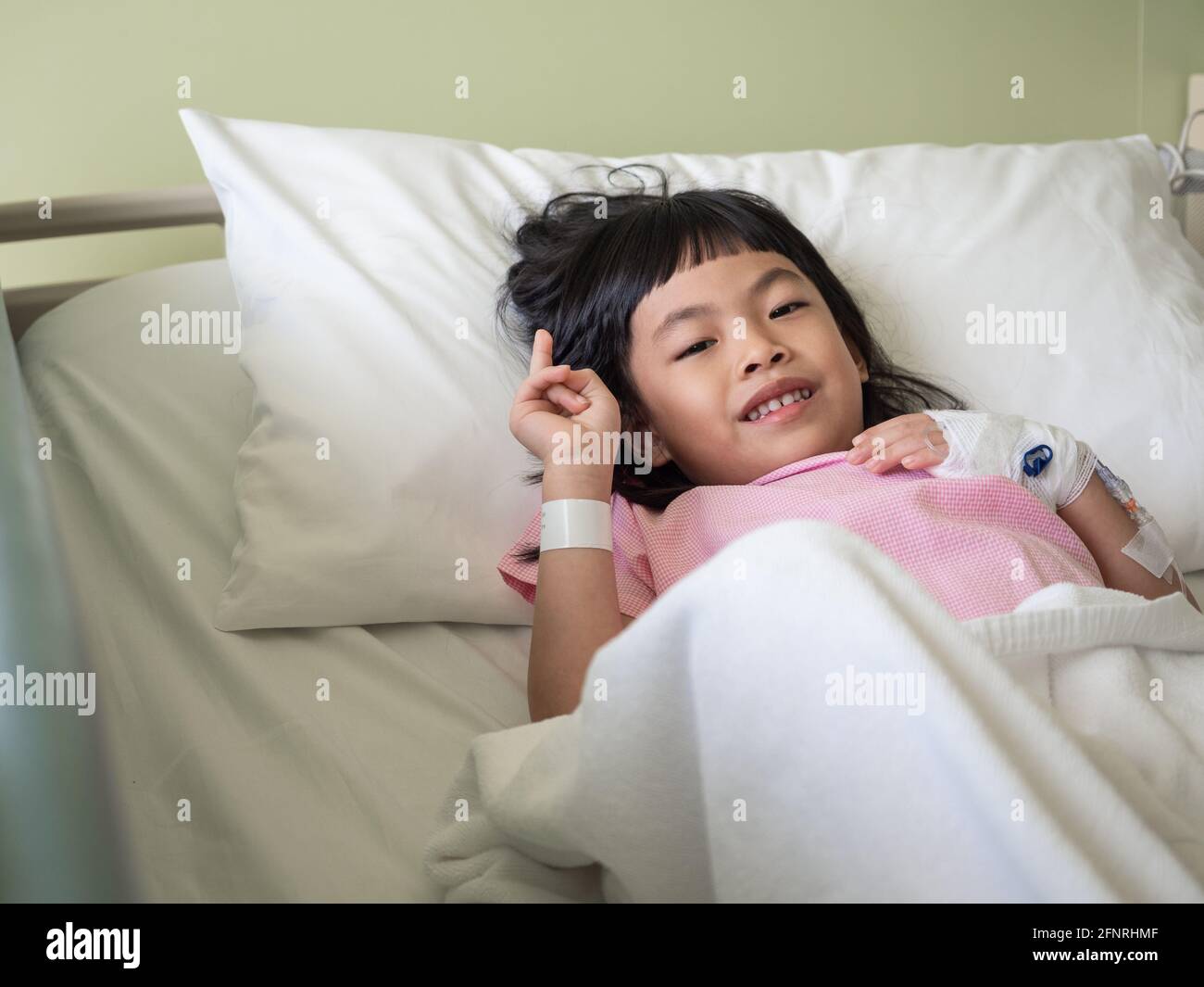 Asian little girl on hospital bed looking at camera Stock Photo Alamy