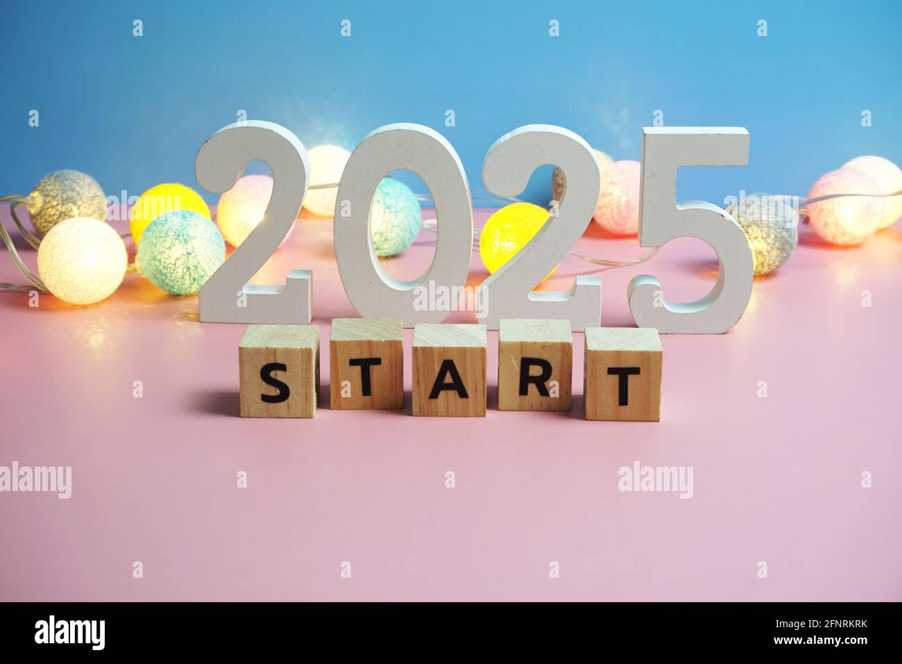 Start 2025 word alphabet letters on pink and blue background Stock