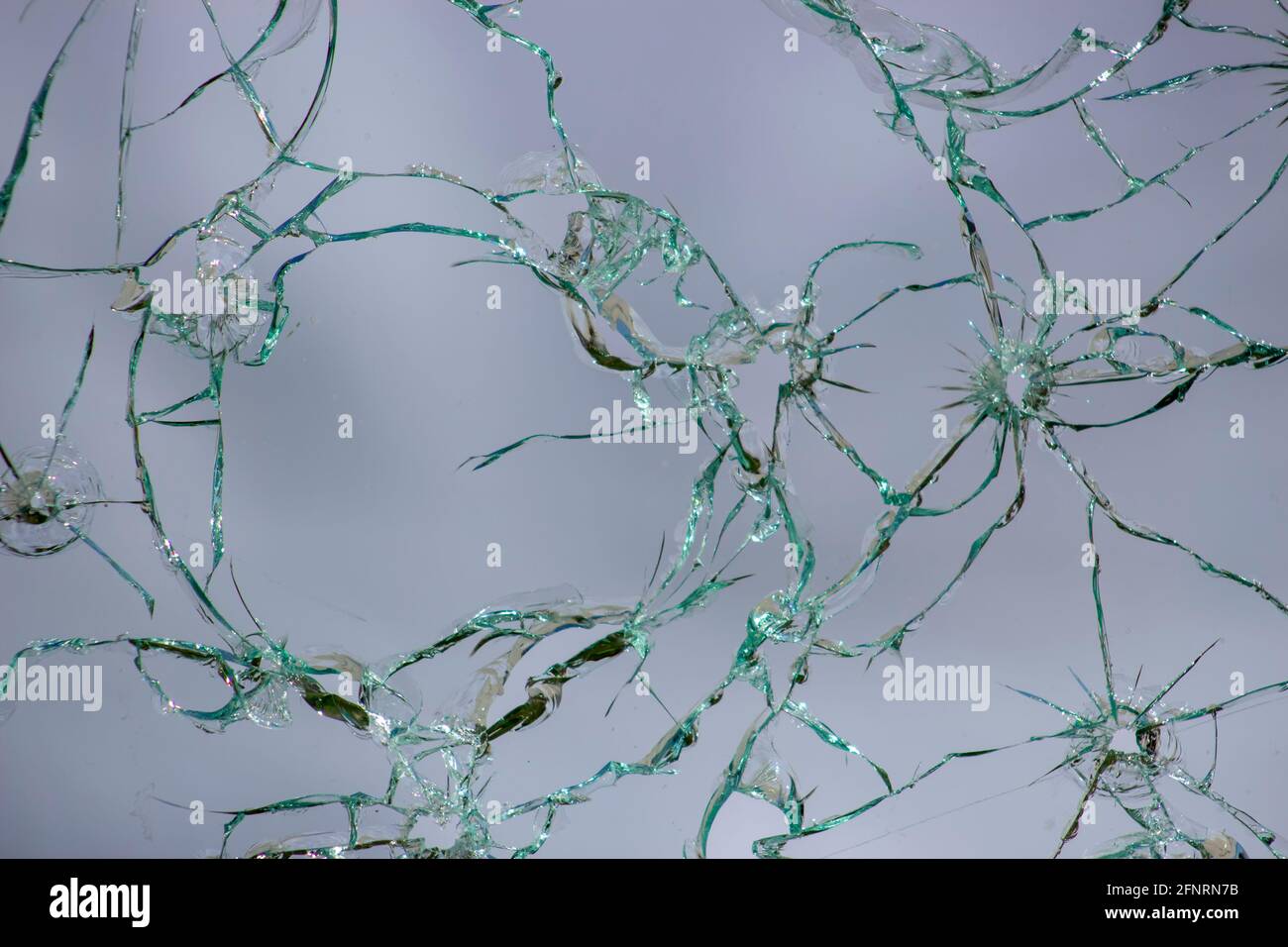 Cracked glass, texture of broken shots of glass on a white background Stock Photo