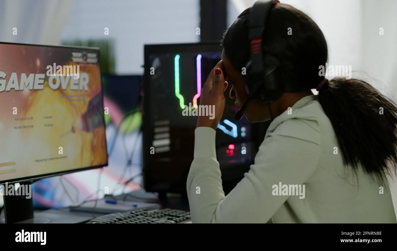 Back shot of pro gamer playing online shooter game on computer using  wireless controller. Competitive player man winning videogame tournament  use professional equipment at home gamming studio Stock Photo - Alamy