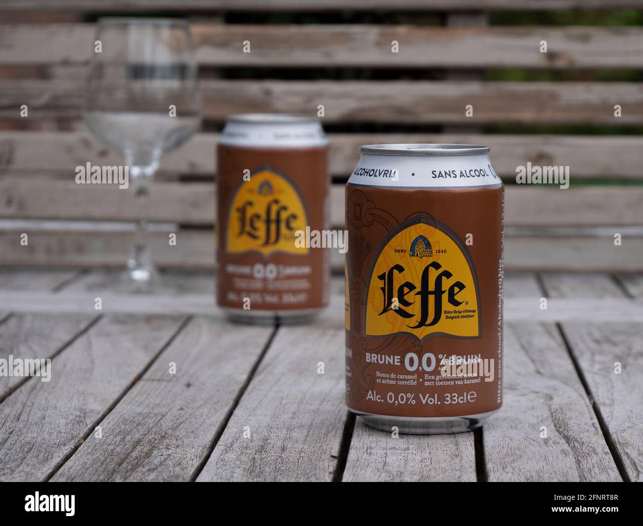 Sint Gillis Waas, Belgium, 16 May 2021, Two cans of Belgian abbey beer and a tasting glass, beer without alcohol, Leffe brown. Stock Photo