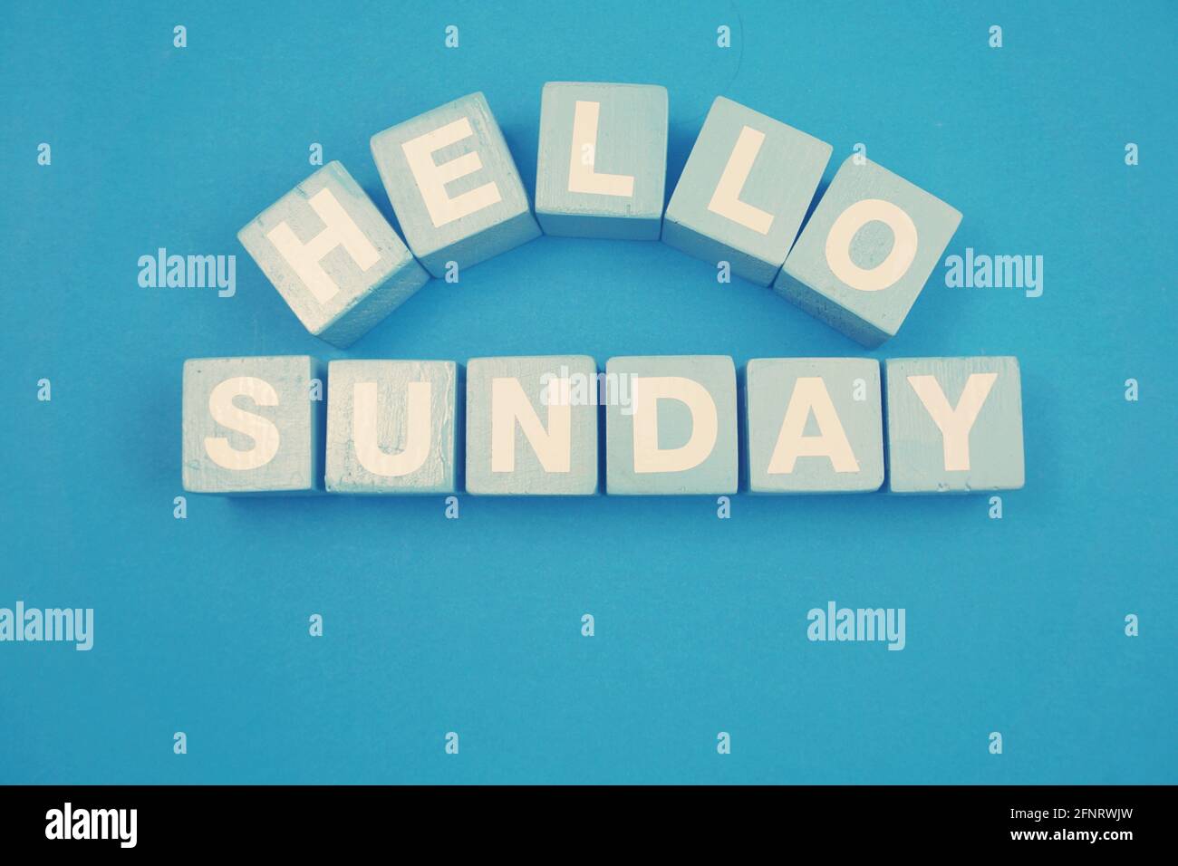 Hello Sunday alphabet letters on blue background Stock Photo - Alamy
