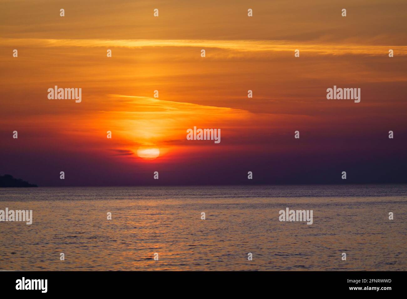 Scenic sunset over calm sea Stock Photo