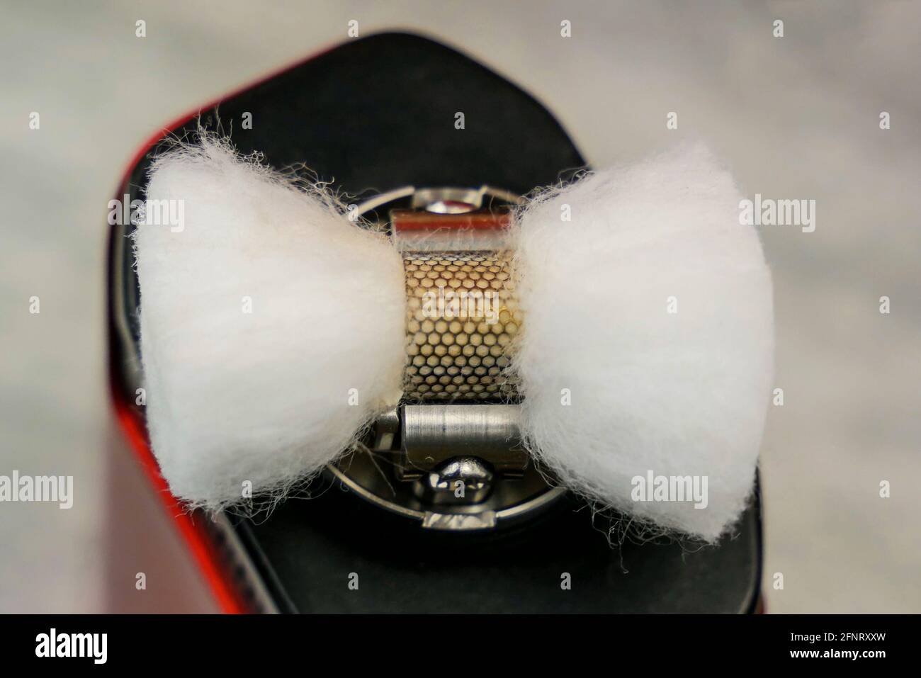 Preparation of mesh coil in the atomizer for vaping - Cutted ends of the  cotton under the coil Stock Photo - Alamy