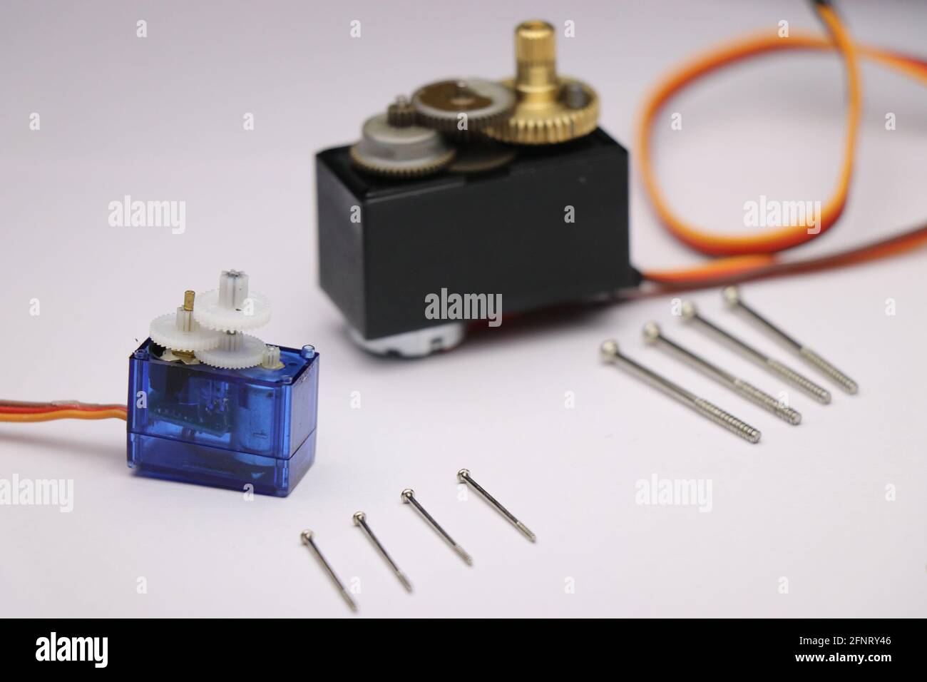 Metal geared servo and plastic geared servo disassembled with visible