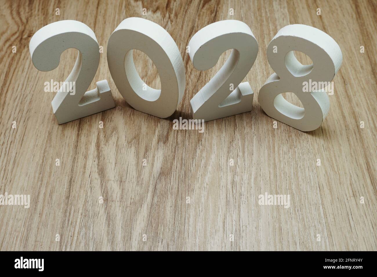 2028 Happy New Year with space copy on wooden background Stock Photo