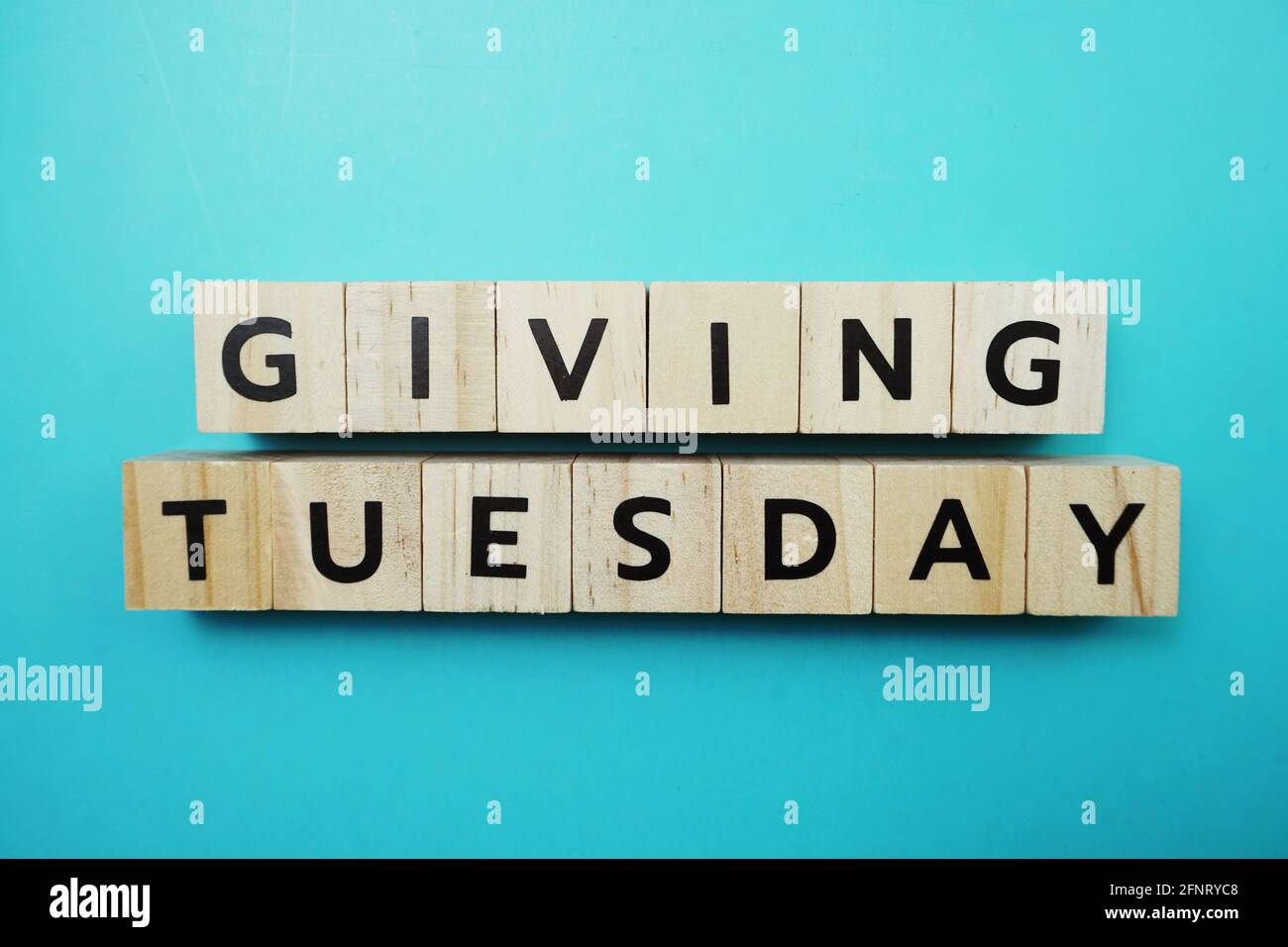 Giving Tuesday alphabet letter on blue background Stock Photo