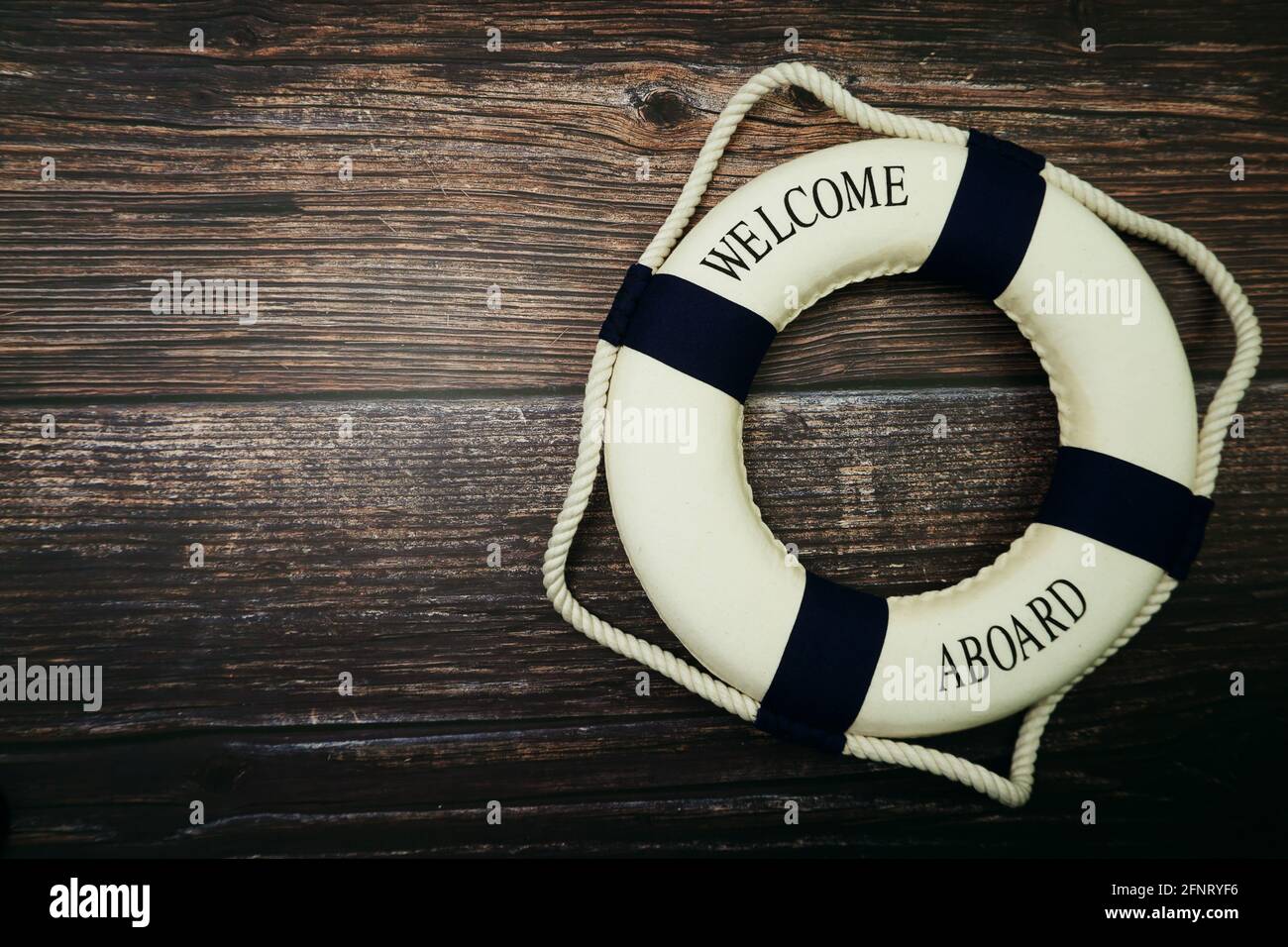 Lifebuoy Marine Decoration with space copy on wooden background Stock