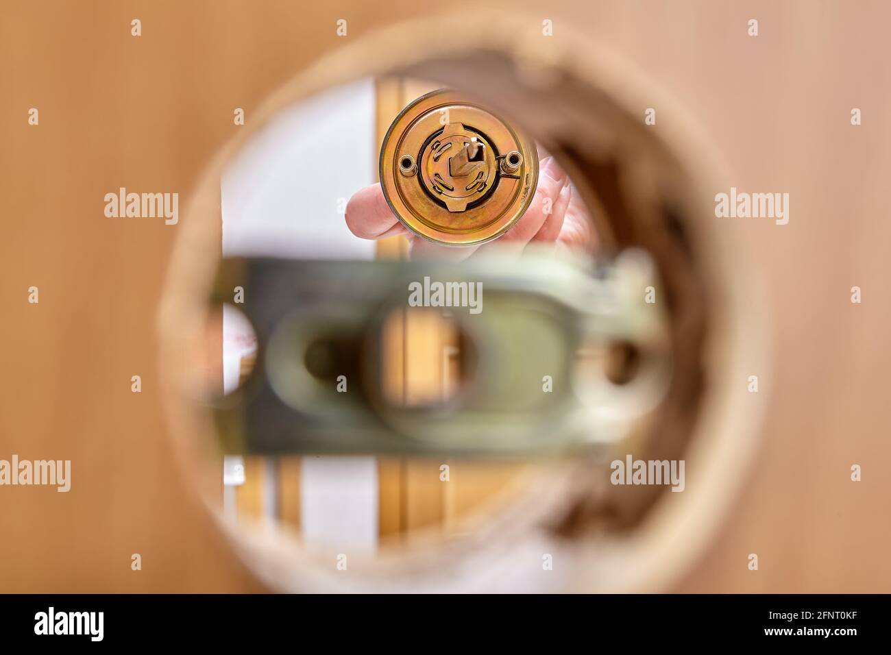 Assembling door lock with knob and latch, inserting bolt into assembly ...