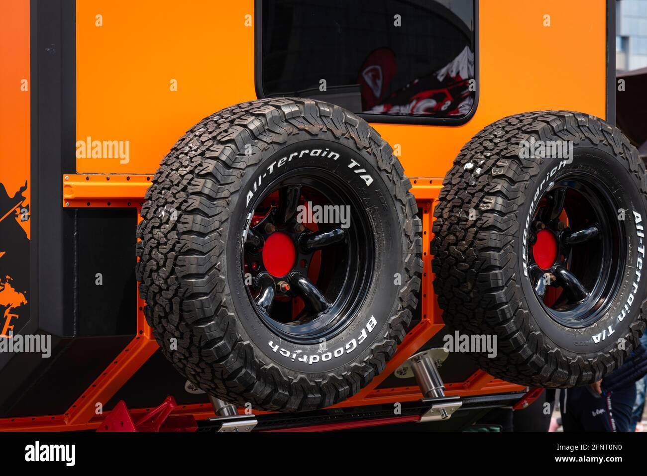 BF Goodrich All-Terrain T/A tyres attached to the back of an orange Land  Rover Defender 4X4 truck Stock Photo - Alamy