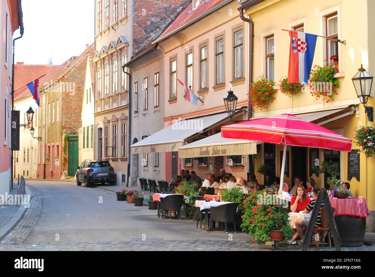 People eating at an outside restaurant in the old city of Zagreb. Stock Photo