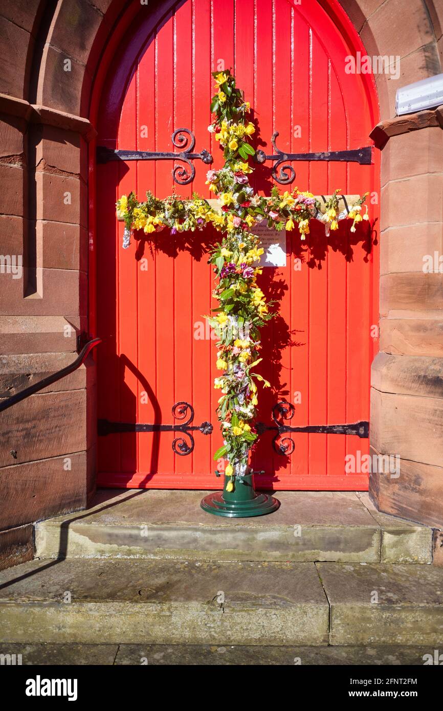 Easter cross made of flowers outside a methodist church in Douglas