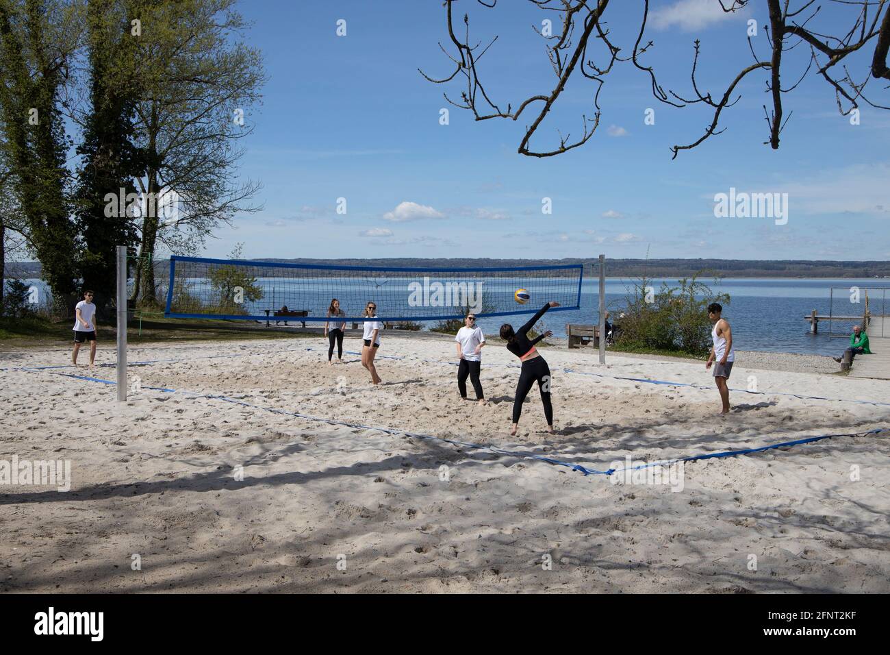 Group of young people playing beach volleyball on the shore of Lake Ammer,Ammersee, Upper Bavaria, Germany,Europe. Stock Photo