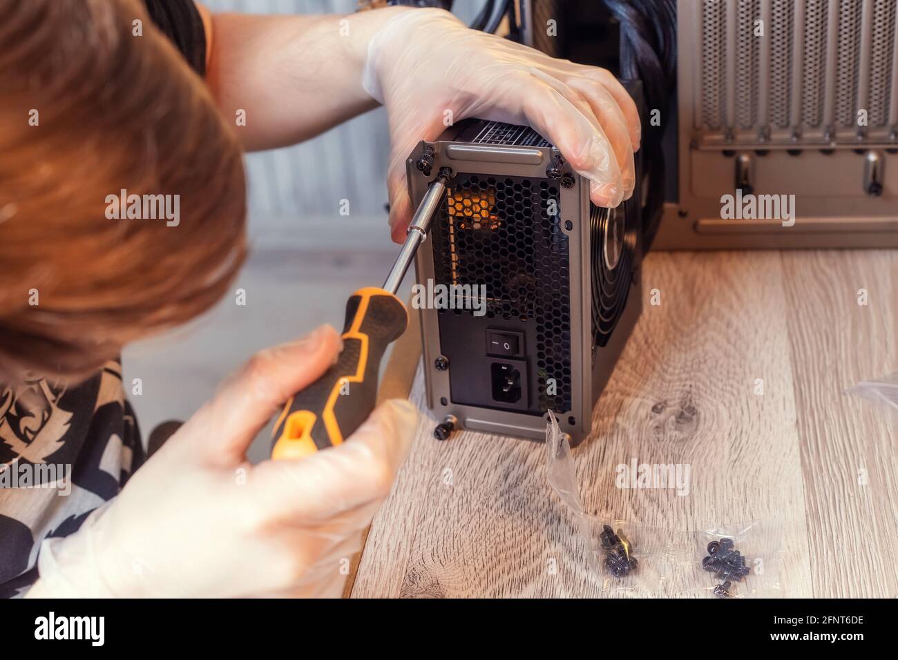 Installing Power Supply Unit into the desktop PC system unit. Computer