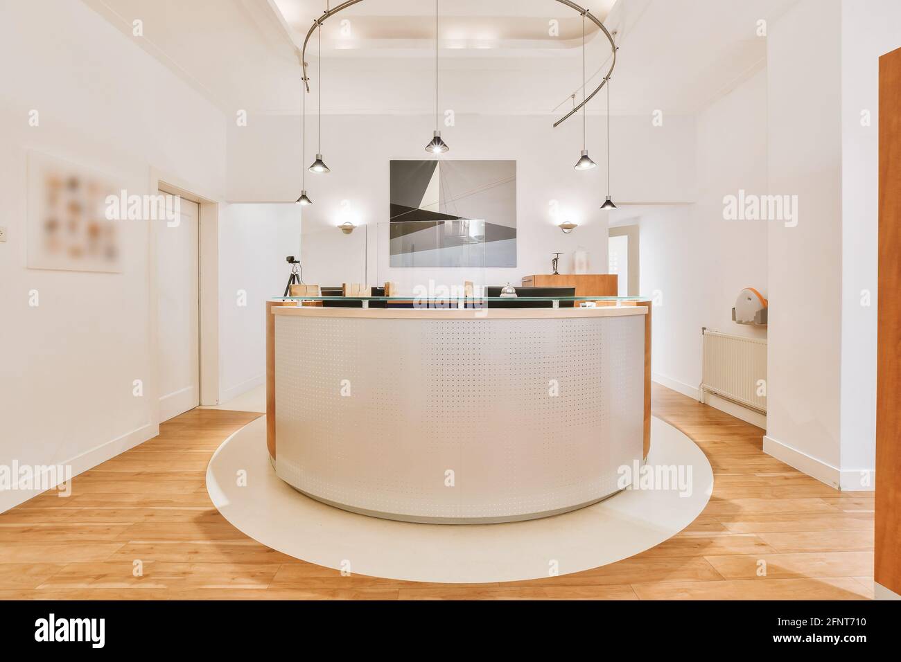Modern counter illuminated with many lamps located on reception of contemporary office Stock Photo