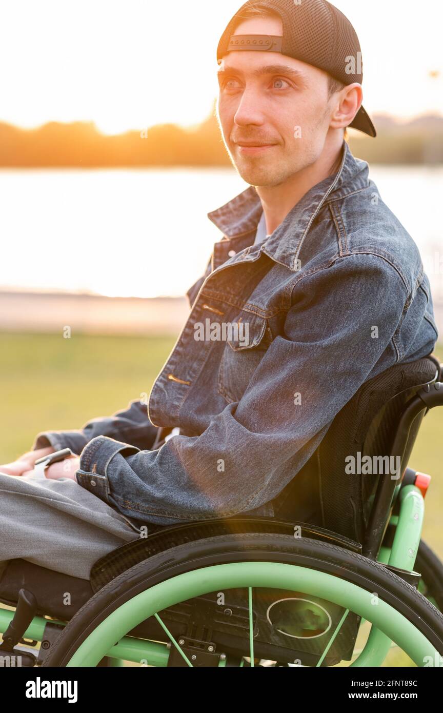 young disabled man in wheelchair walking park Stock Photo Alamy