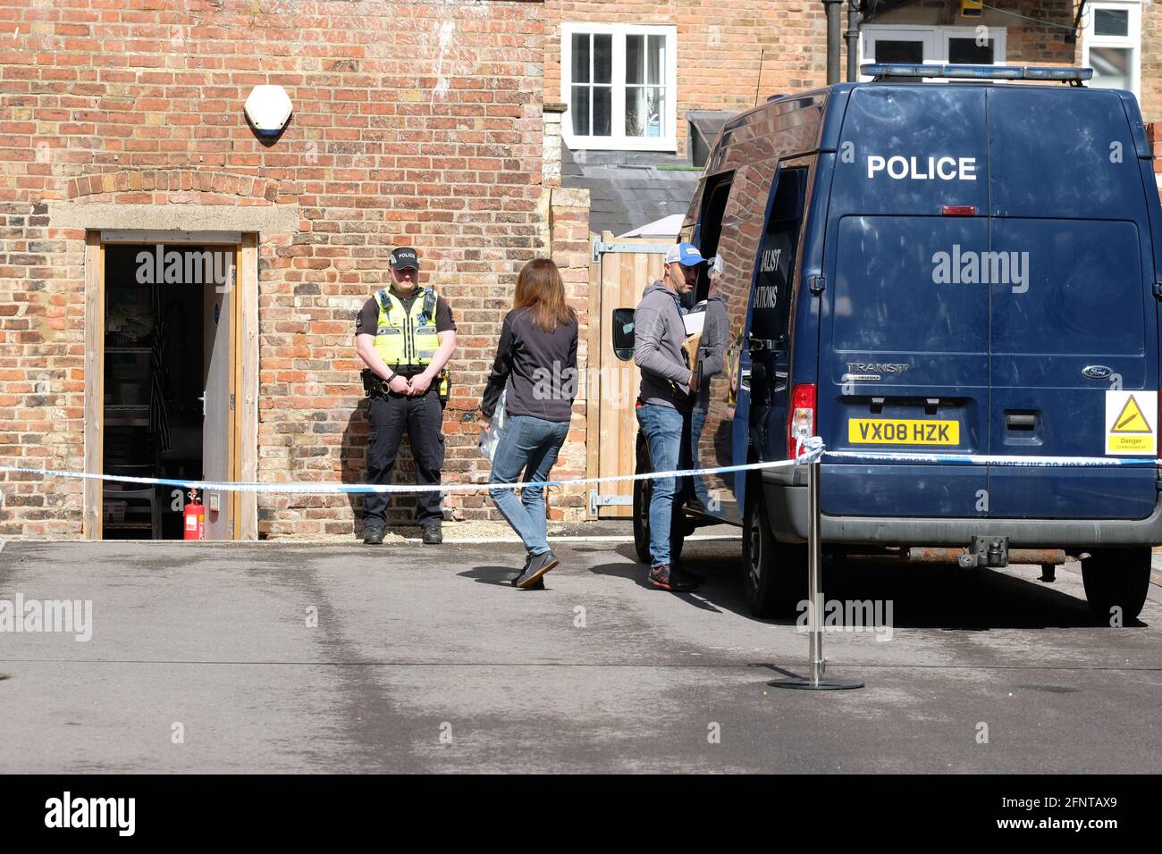 Gloucester, Gloucestershire, UK - Wednesday 19th May 2021 - Police take kit and supplies into the rear of the  Clean Plate cafe as Police begin excavations in the search for Mary Bastholm who went missing in 1968 aged just 15 years old and who may have been a victim of serial killer Fred West. Photo Steven May / Alamy Live News Stock Photo