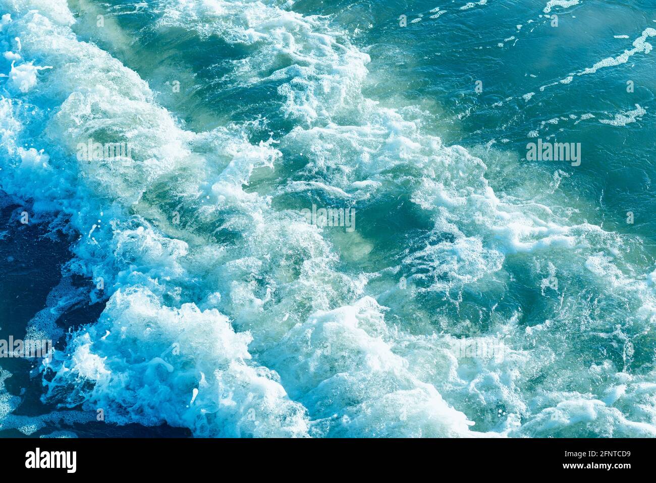 Areal shot of deep blue and rough sea with lot of sea spray.Blue ...