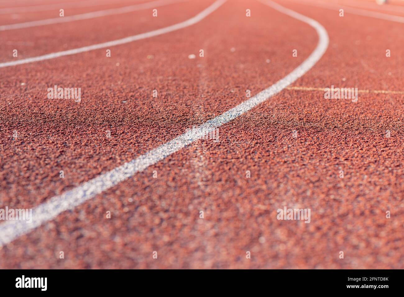 Part Red plastic track in the outdoor track and field stadium.Closeup. Stock Photo