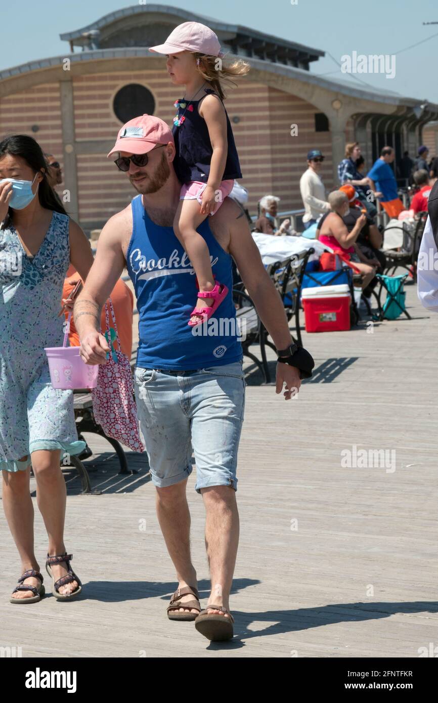 A father carries his daughter on his shoulders in Coney Island, Brooklyn, New York. Stock Photo