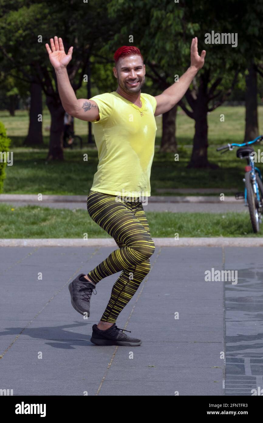 An energetic Zumba dance exercise instructor leads a class in Flushing Meadows Corona Park in Queens, New York City. Stock Photo