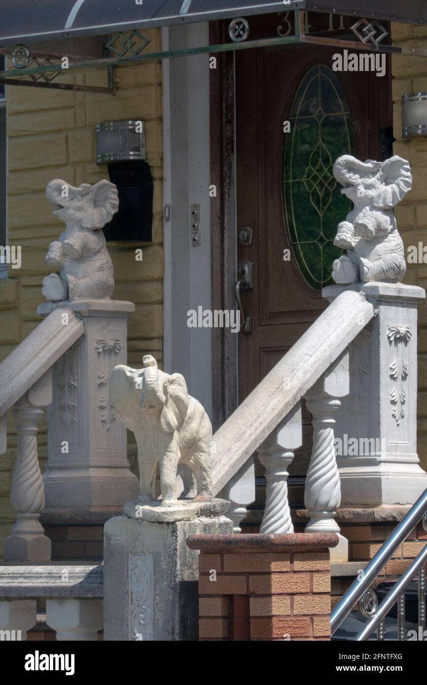 An entrance stairway decorated with 3 stone elephants. In Corona, Queens, New Yorrk City. Stock Photo