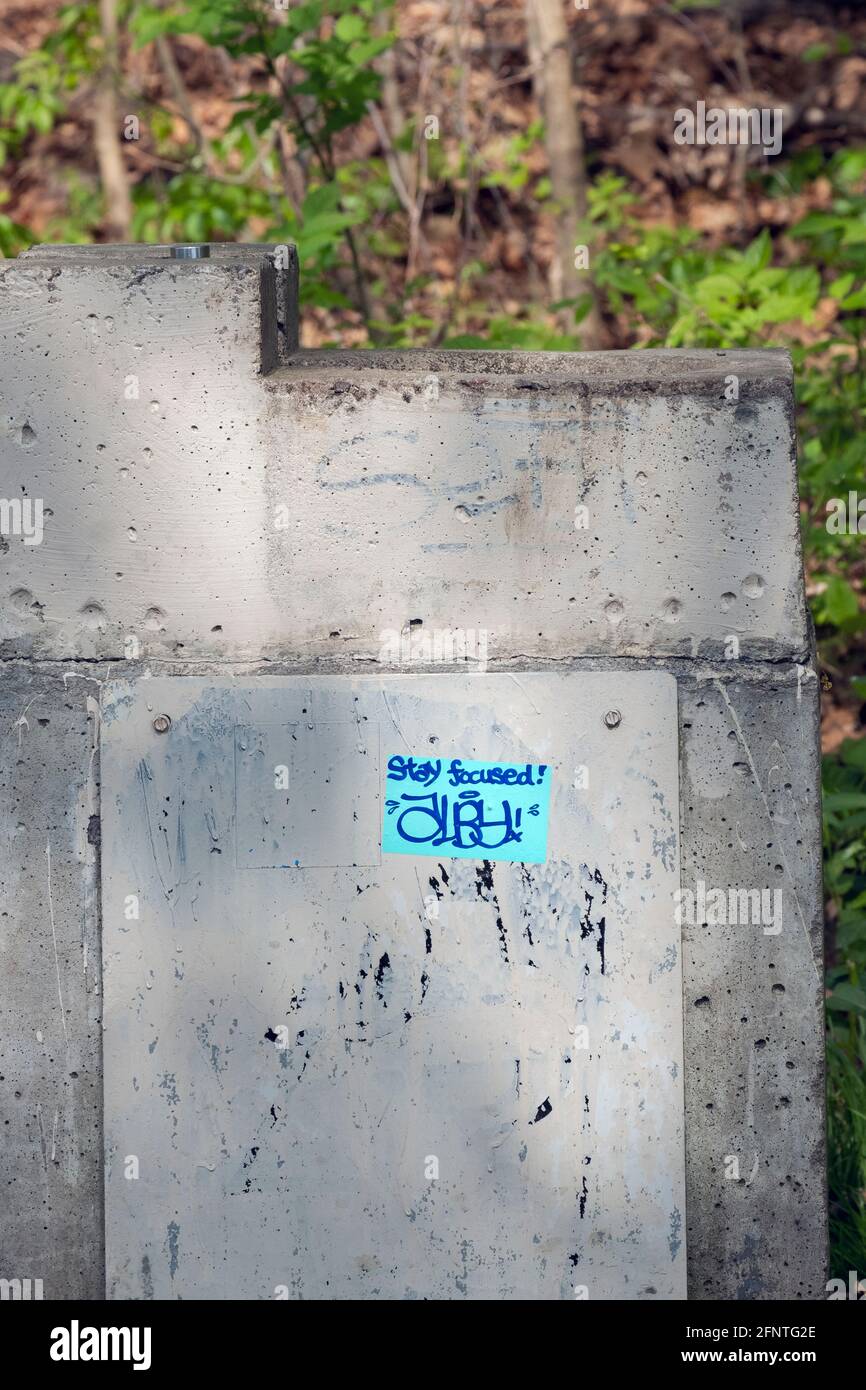 A fountain with a blue sticker advising us to stay focused. In New York City. Stock Photo