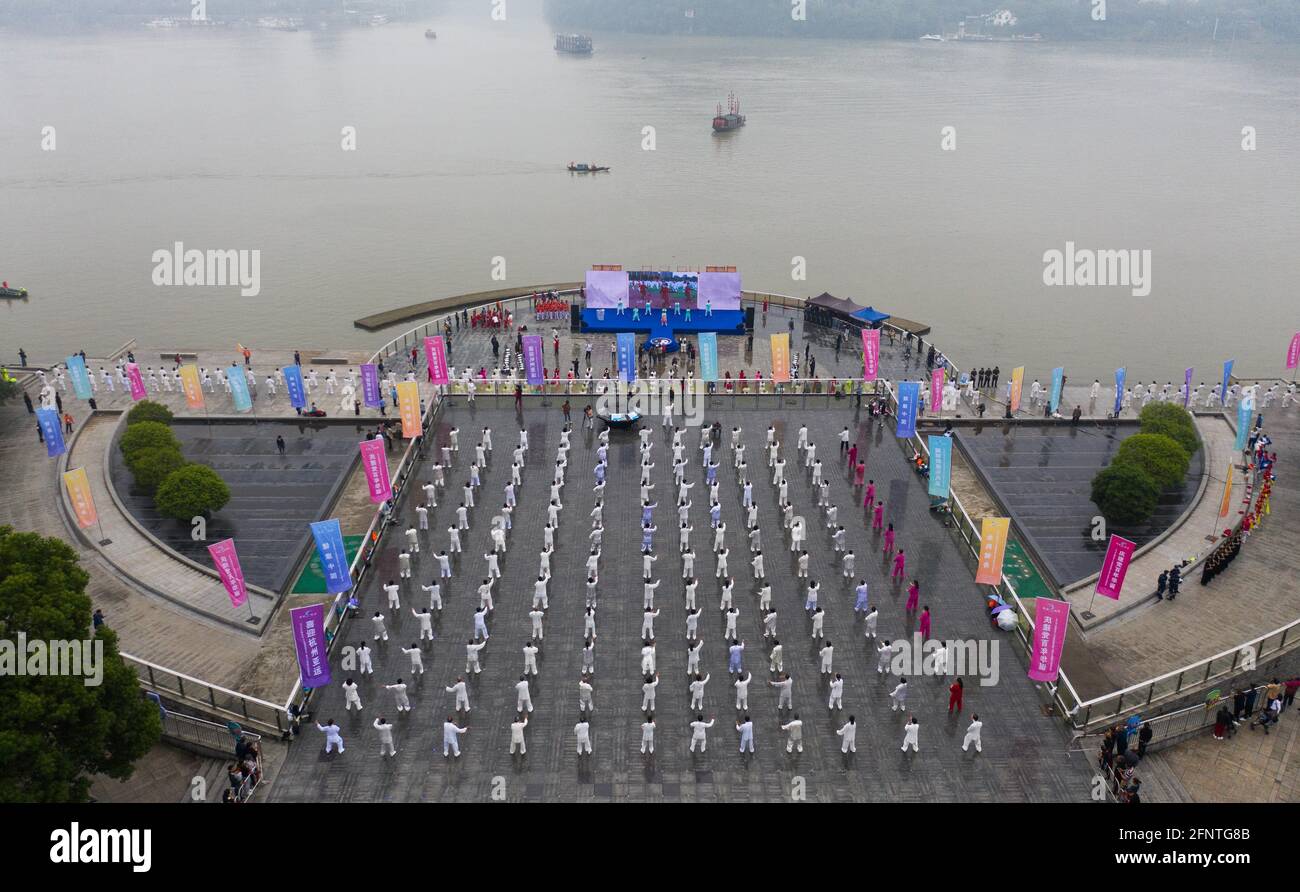 Tonglu. 19th May, 2021. Aerial photo taken on May 19, 2021 shows senior hobbyists of Taijiquan, a traditional Chinese martial art, demonstrating Taijiquan moves by Fuchunjiang River in Tonglu County, east China's Zhejiang Province. A nation-wide campaign to promote and demonstrate Taijiquan as a fitness exercise among senior citizens was launched here on Wednesday. More than 2,000 Taijiquan hobbyists from all over the country flocked in to participate in the demonstrations and performances. Credit: Xu Yu/Xinhua/Alamy Live News Stock Photo