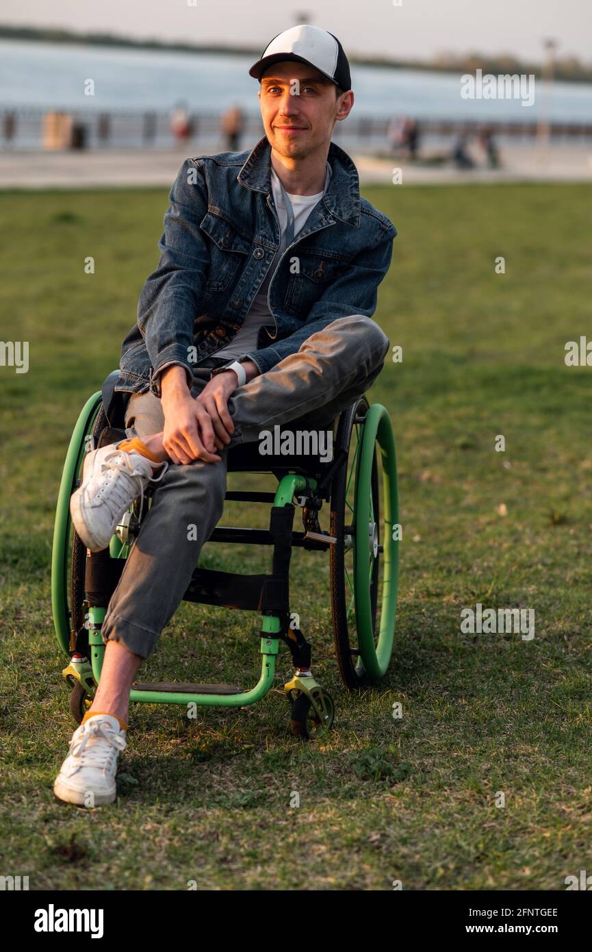 Close up. Disabled Man on Wheelchair outdoor. Disabled Young Man. Man on Wheelchair. Recovery and Healthcare Concepts Stock Photo