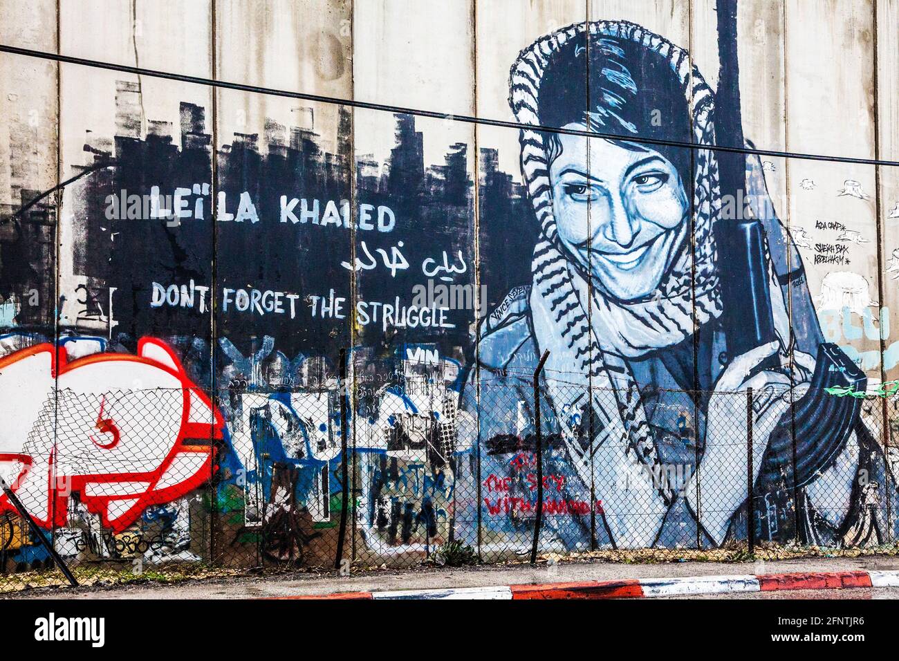 Graffiti of Leila Khaled on the Israeli West Bank Barrier near Bethlehem. Stock Photo