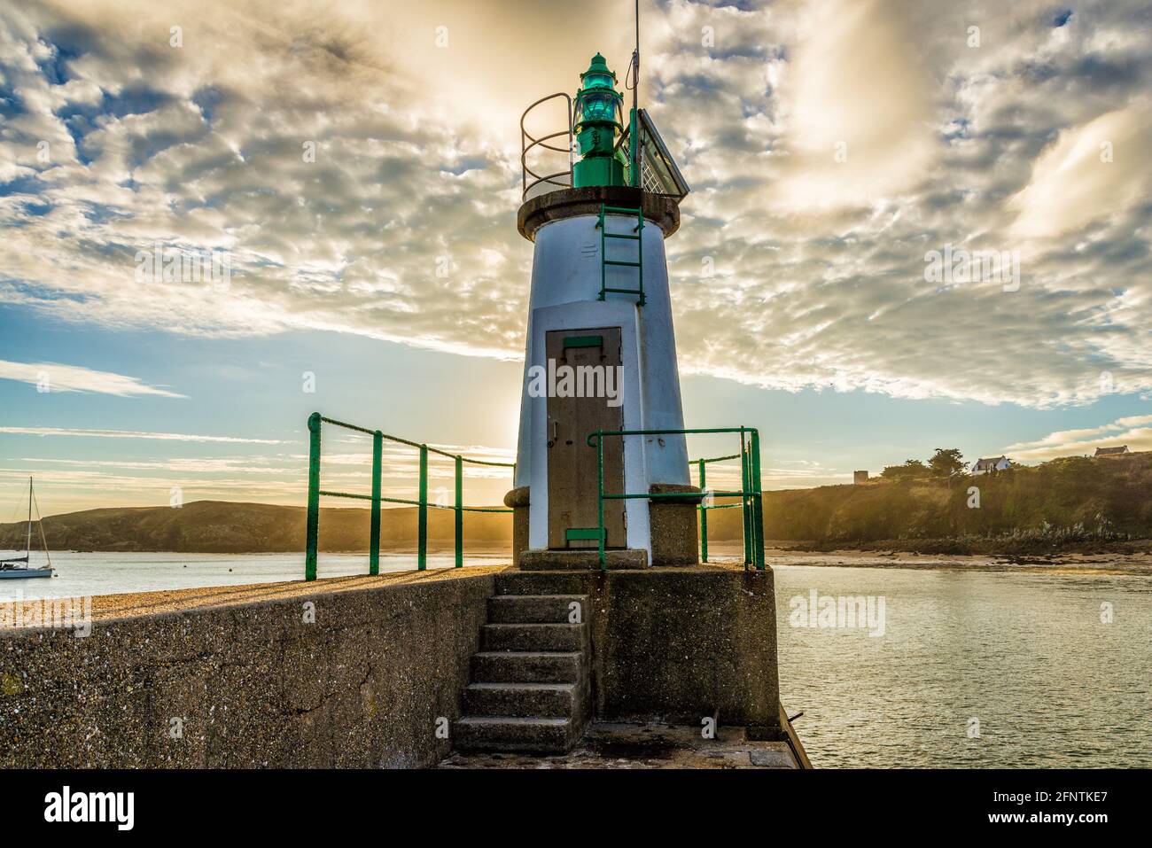 Small lighthouse at the entrance to the harbor of island Houat, France Stock Photo