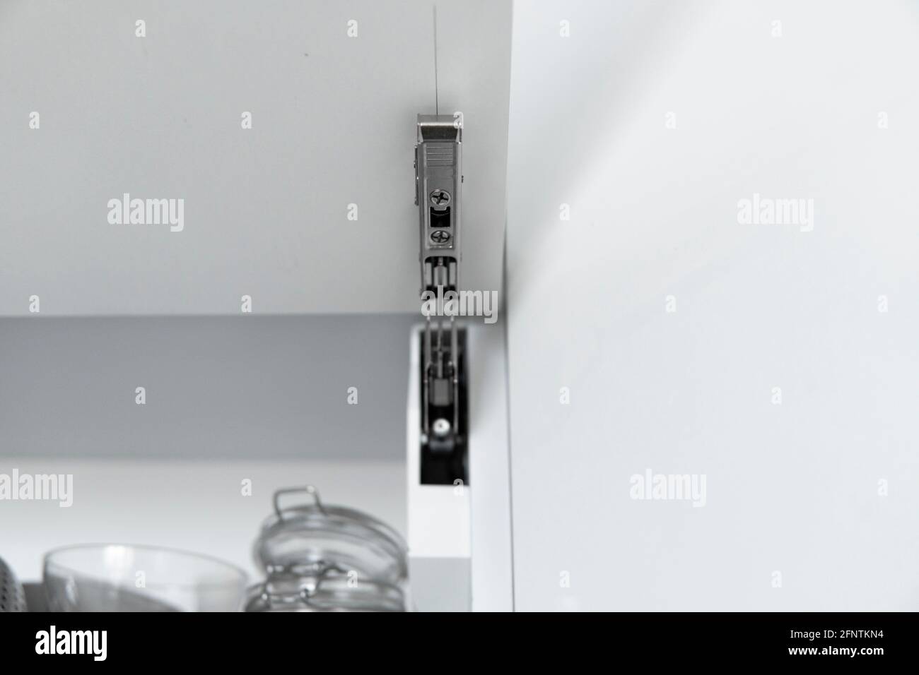 Kitchen with open fronts. Lift system for bifold fronts for