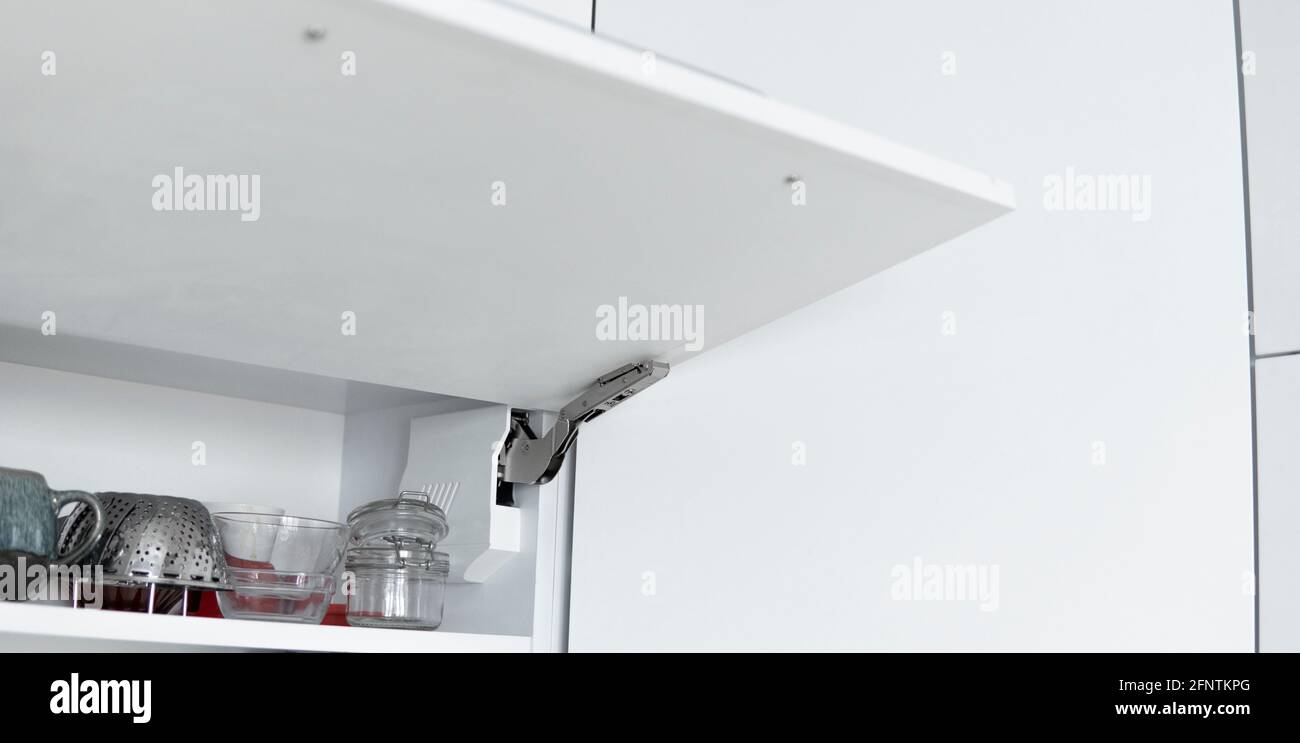 Kitchen with open fronts. Lift system for bifold fronts for