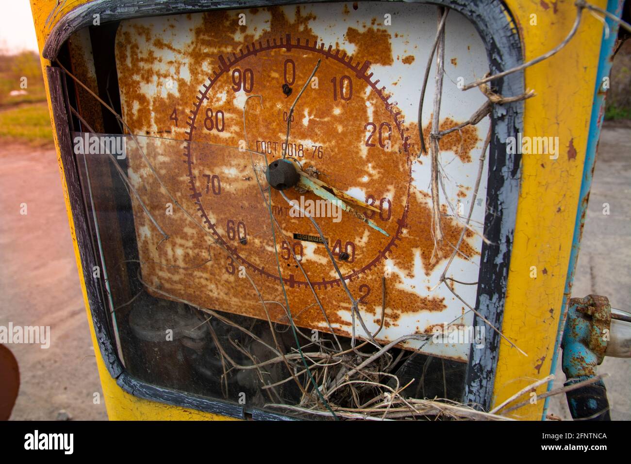 Old vintage gas station. Rusty dial with broken glass and inscriptions in Russian. Stock Photo