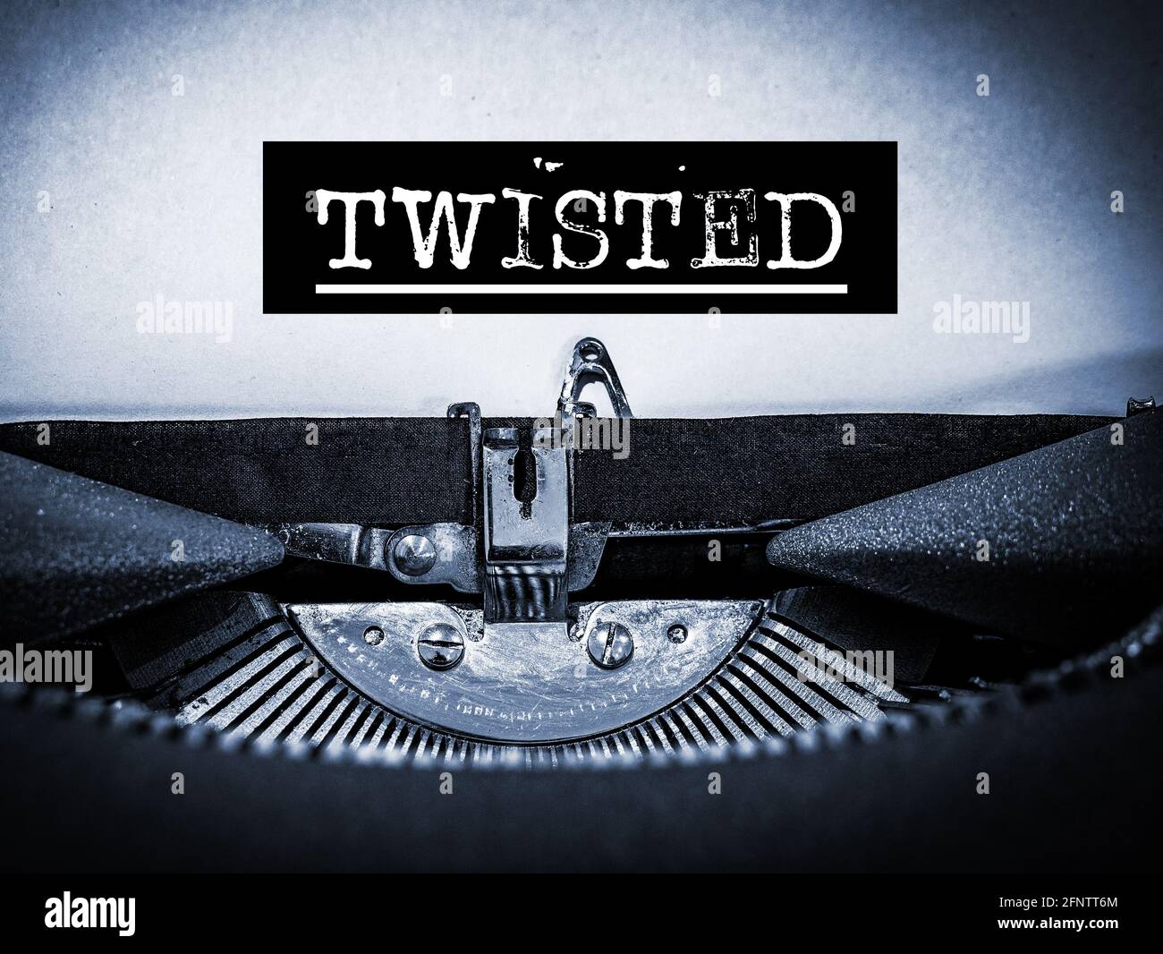 Twisted displayed on a vintage typewriter with underline script and black border in a blue tone Stock Photo