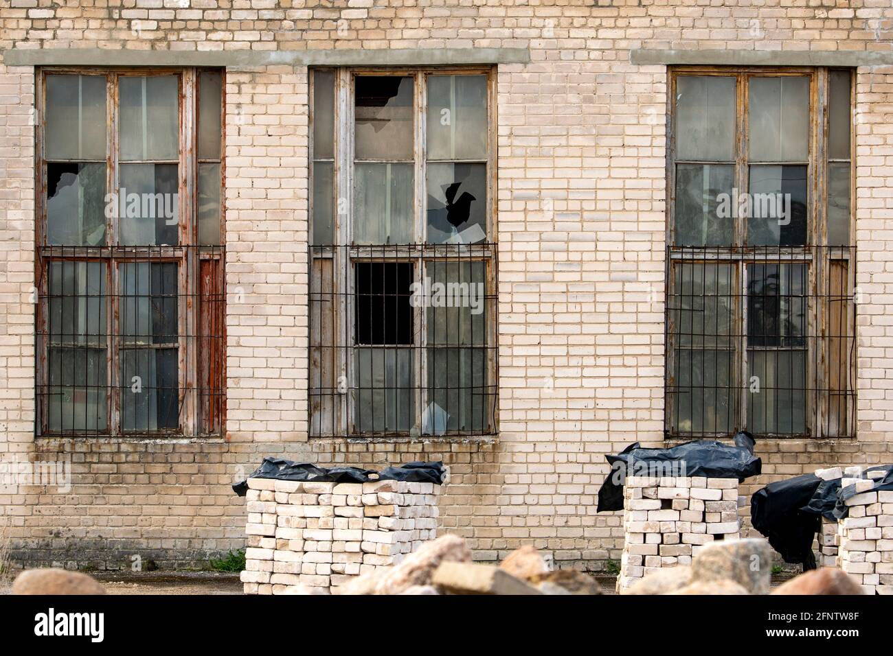 Broken windows in an old abandoned industrial building Stock Photo - Alamy