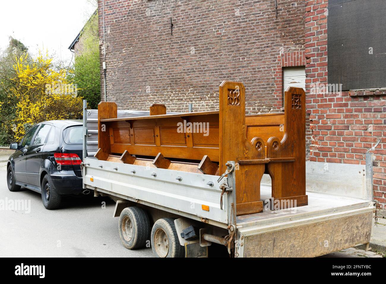 Two pews are transported on a trailer by cart Stock Photo