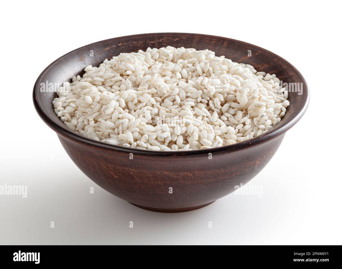 Uncooked arborio rice in ceramic bowl isolated on white background with