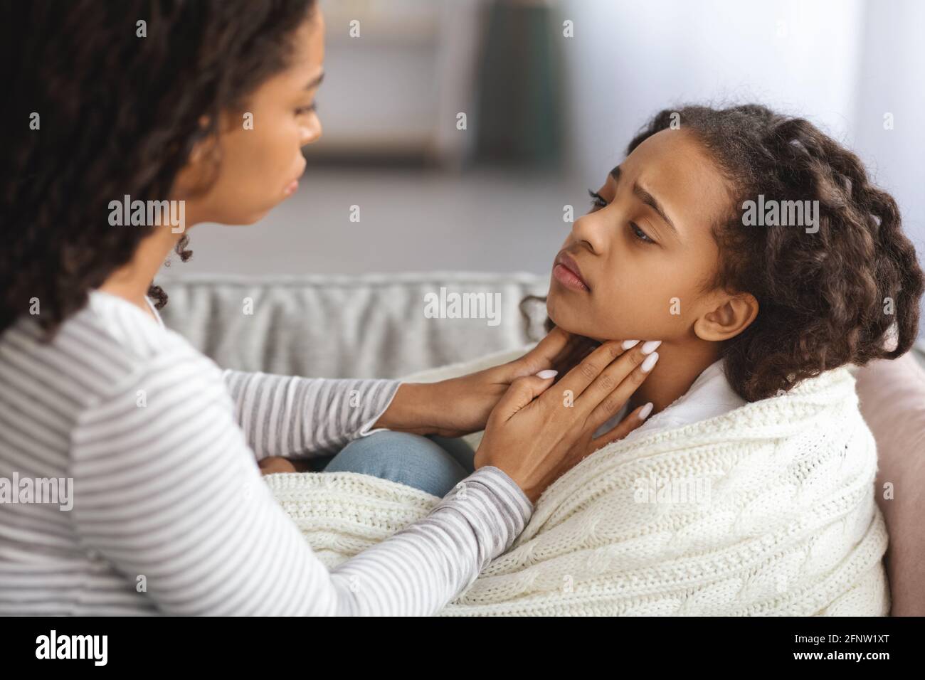 Little girl suffering from sore throat, laying on couch Stock Photo Alamy