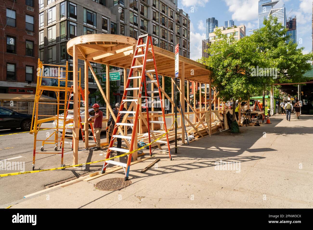 New York, USA. 18th May, 2021. Workers construct an al fresco dining pavilion for the Empire Diner in Chelsea in New York in anticipation of the the imminent reopening of the restaurant, seen on Tuesday, May 18, 2021. ( Photo by Richard B. Levine) Credit: Sipa USA/Alamy Live News Stock Photo