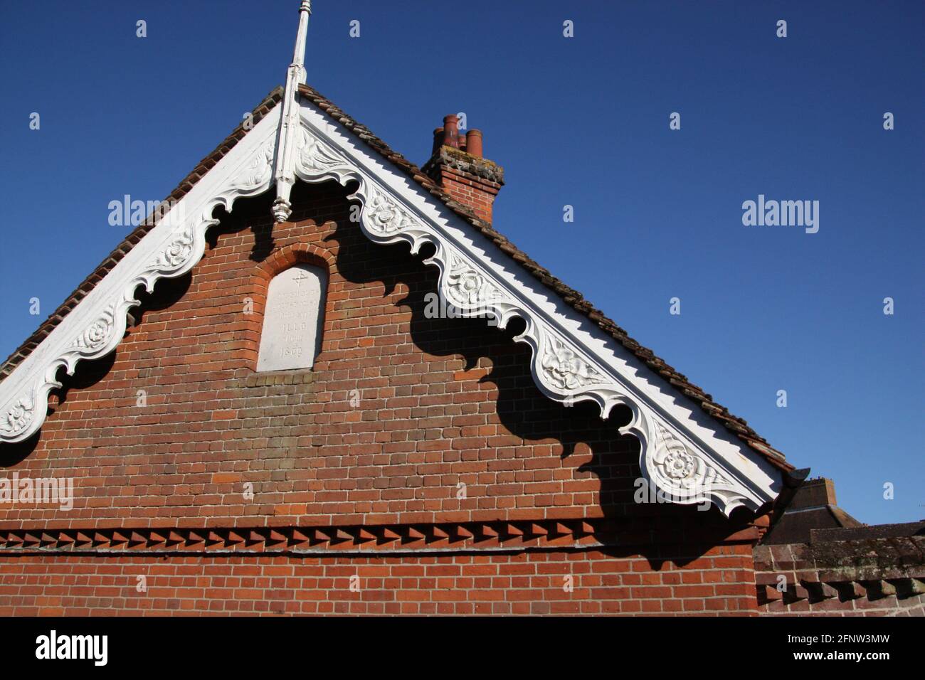 The carved gable end of the Alms cottages in Bocking Essex Stock Photo