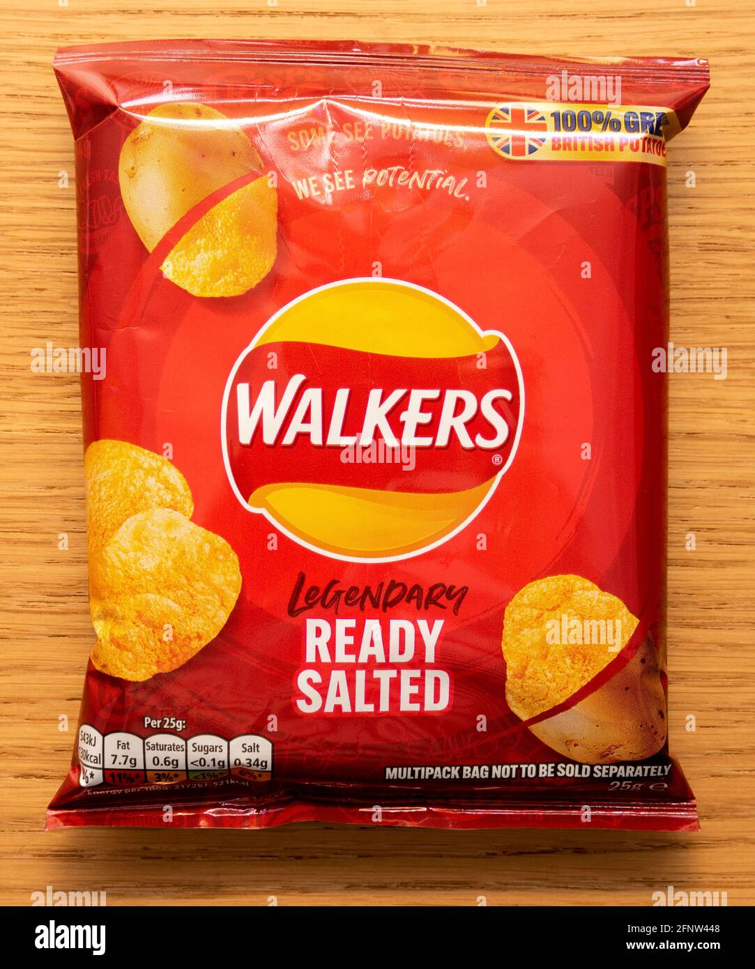 A packet of Walkers legendary ready salted potato crisps on a wood effect background Stock Photo