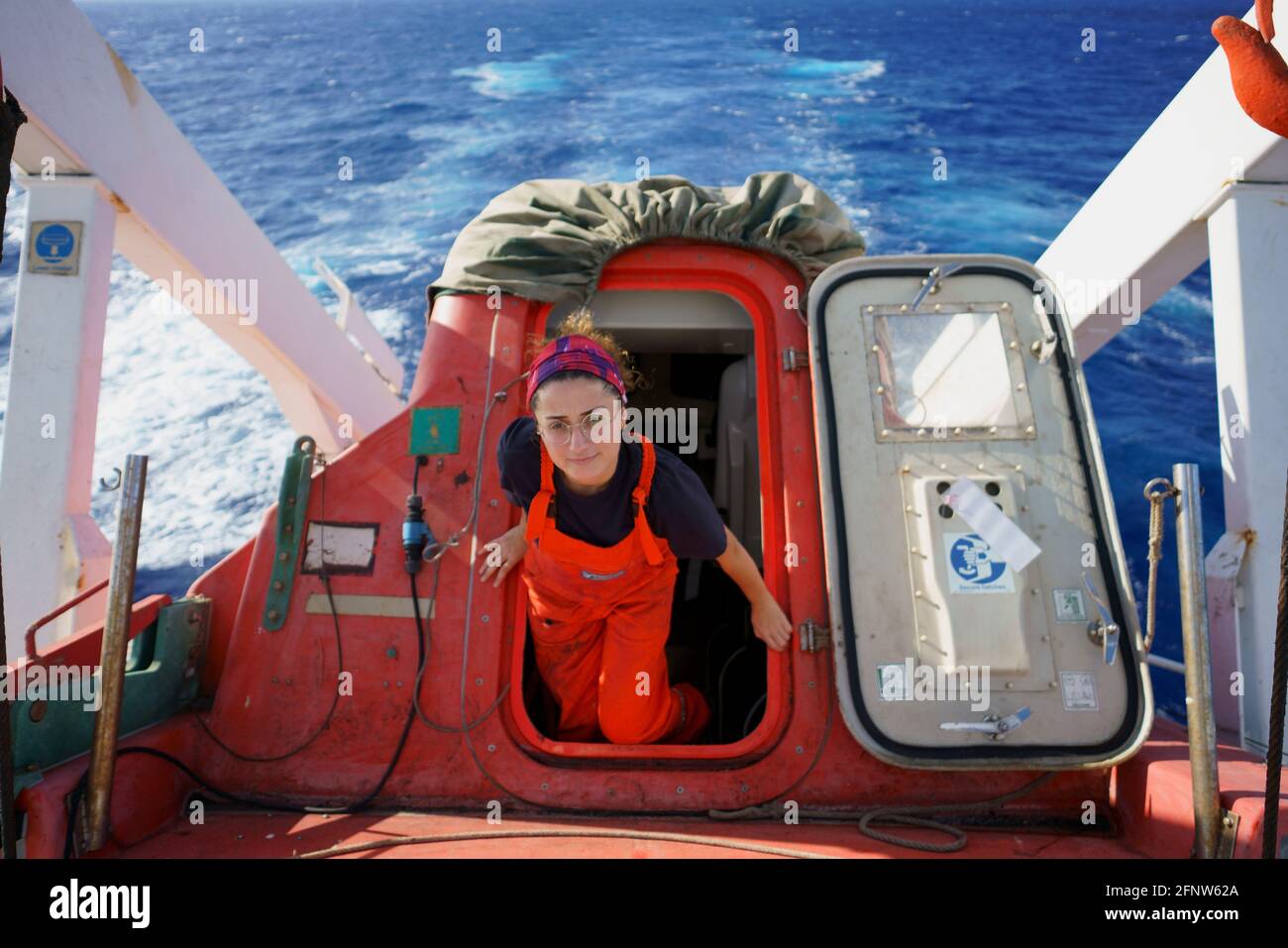 woman deck officer during life boat maintenance Stock Photo