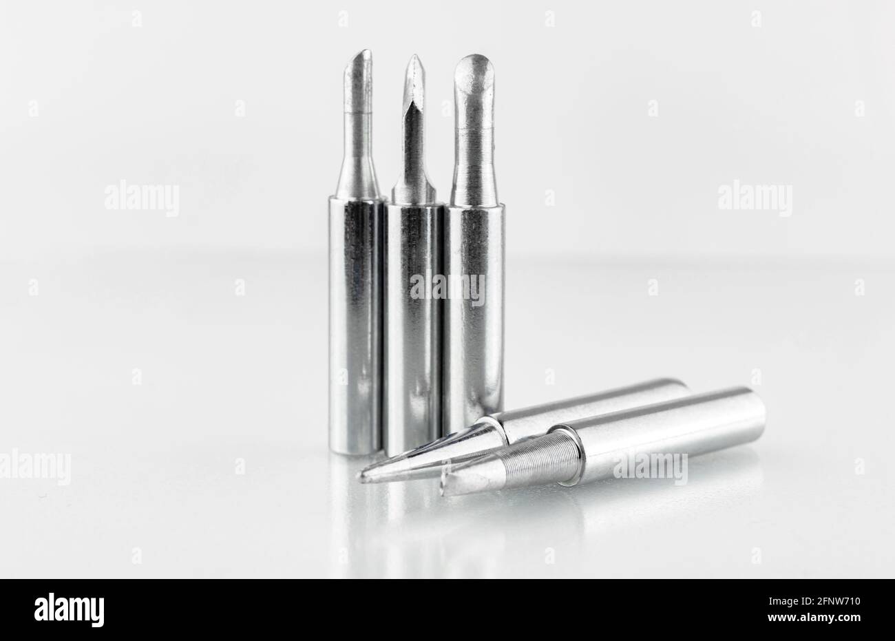 Set of soldering tips for soldering iron on glass table background, closeup Stock Photo Alamy