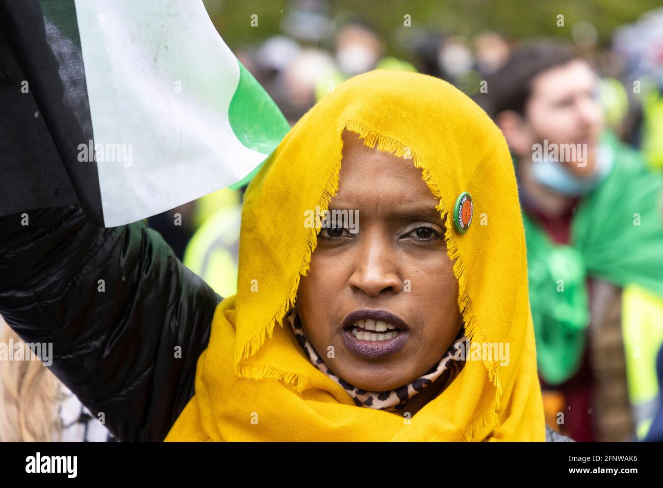 Portrait of protester in yellow hijab, 'Free Palestine' solidarity protest, London, 15 May 2021 Stock Photo