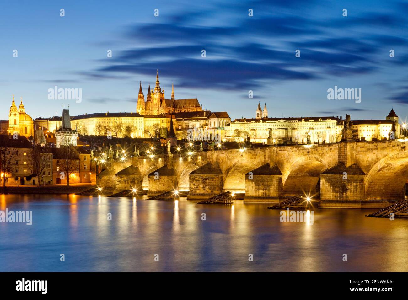 Prague, Czechia. Hradcany castle and Charles bridge at dusk. Stock Photo